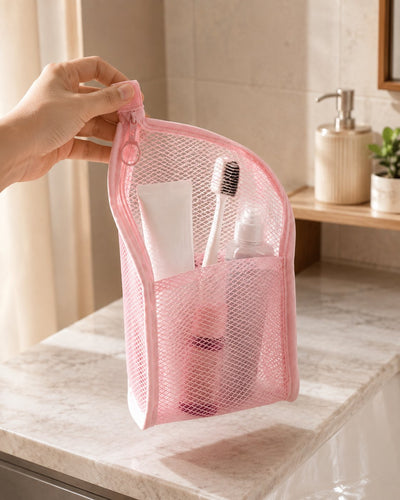 Pink organizer held by its zipper tab