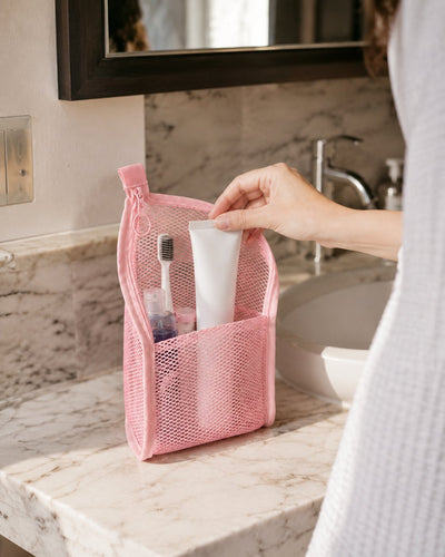 Reaching for a tube in the pink organizer