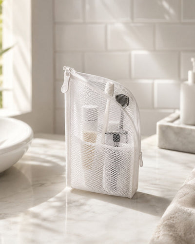 White organizer in morning light with toothbrush and razor